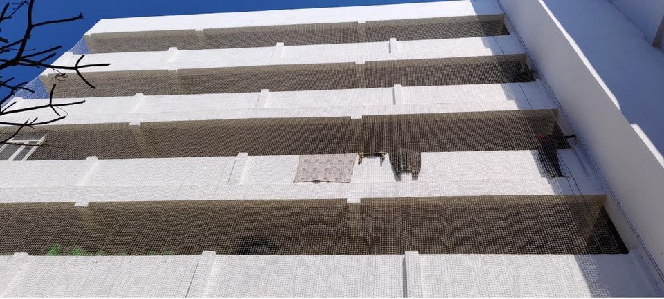 Protective net fitted across an apartment building