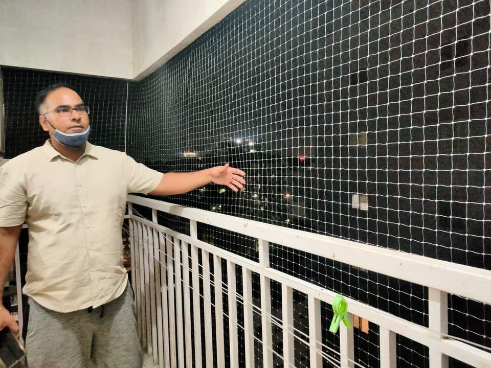 Customer showing a completed balcony pigeon net at night