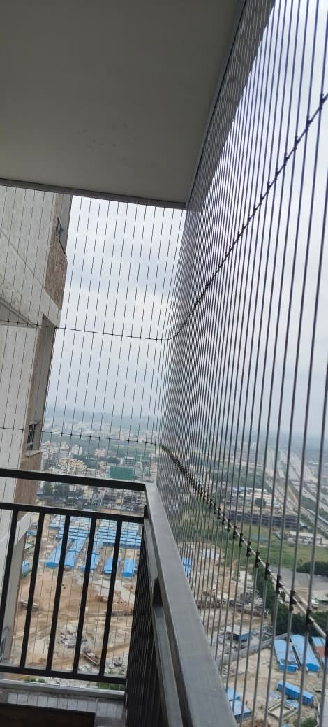 Invisible grills protecting a high-rise corner balcony
