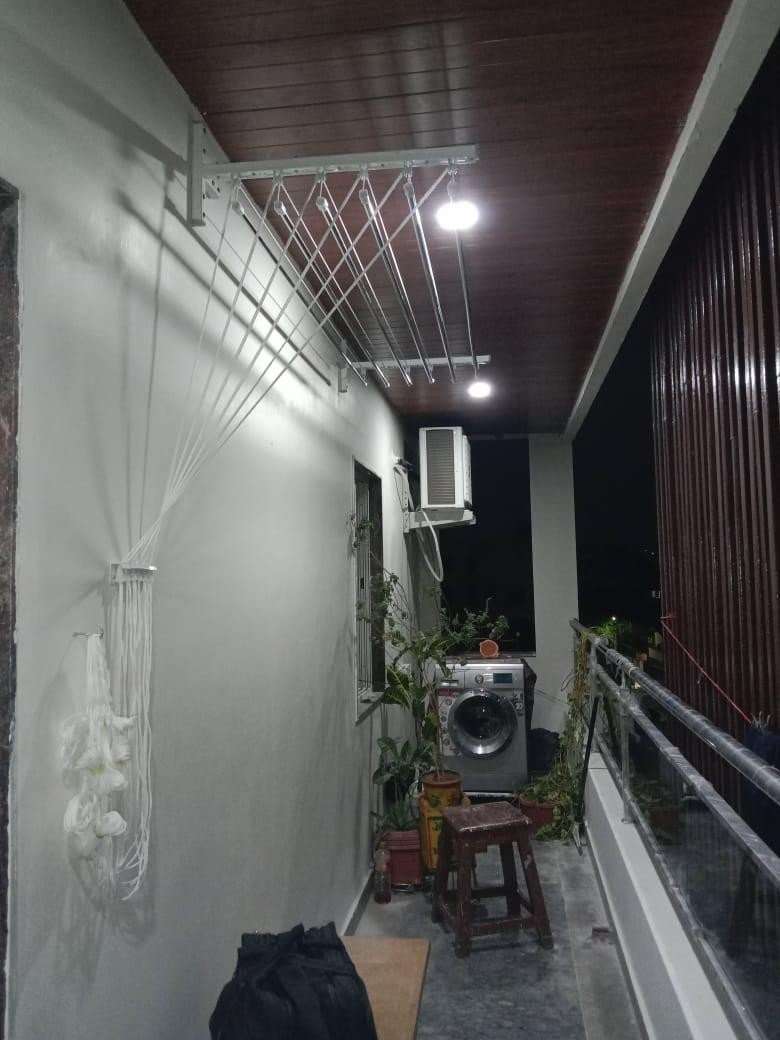 Ceiling cloth hanger installed on a balcony at night