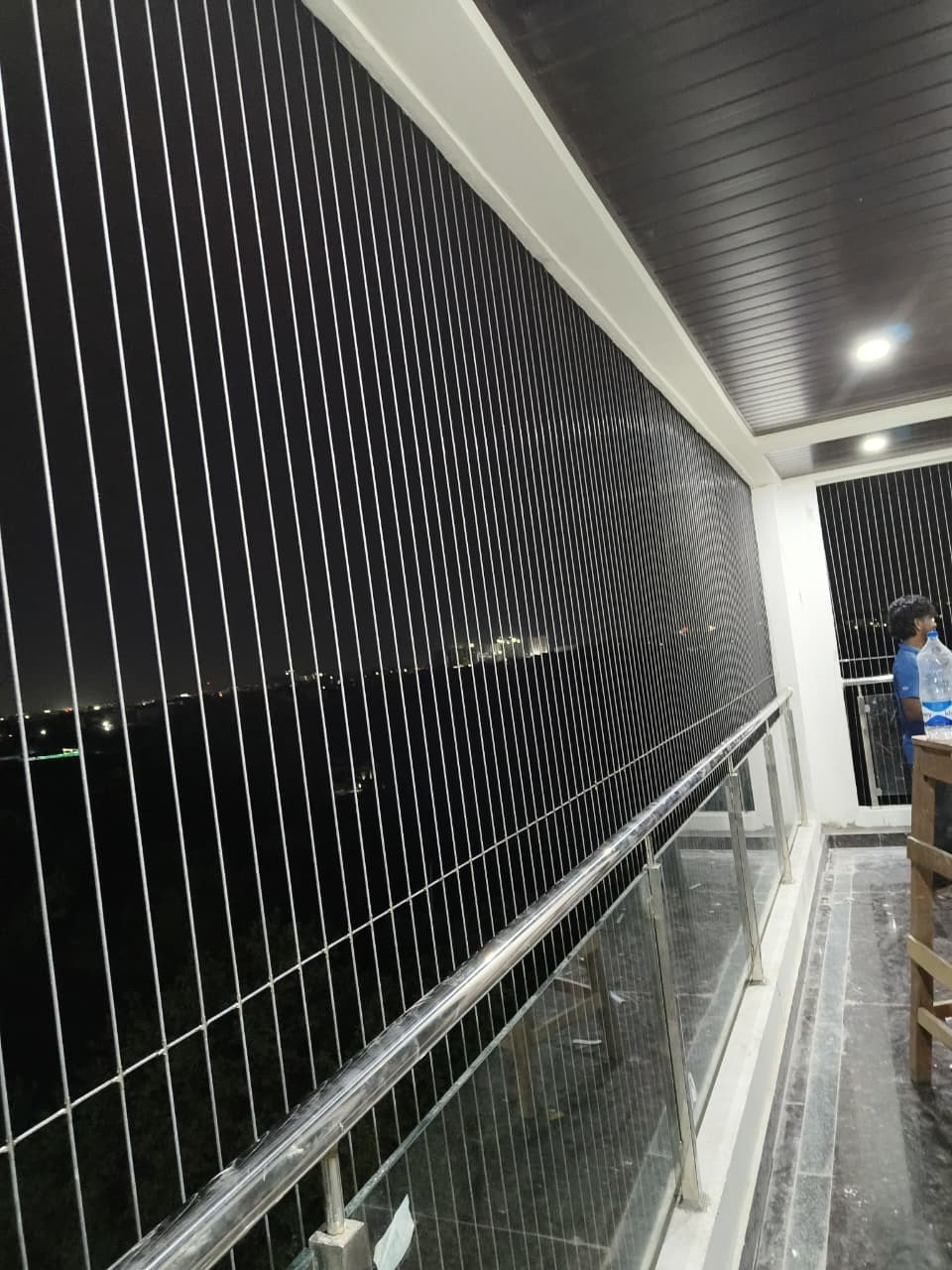 Invisible grills protecting a large balcony at night